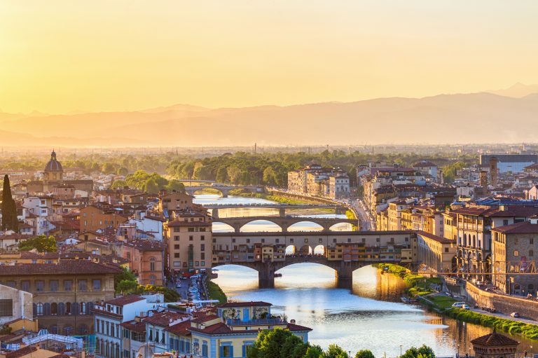 View of Florence at sunset with the Ponte Vecchio Bridge and the Arno River