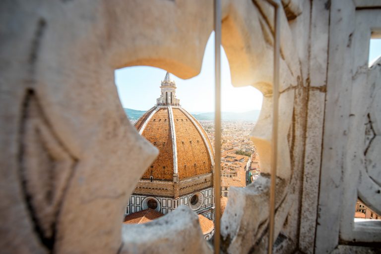 View through the gothic rose window on Duomo cathdral in Florence